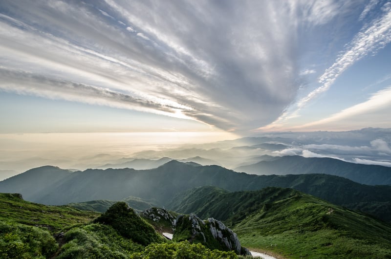 Misty mountain range among low clouds